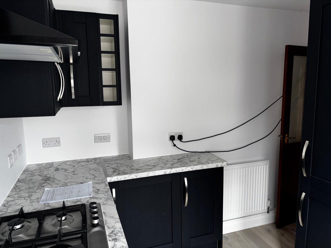 A navy kitchen mid refit with new socket positions wired