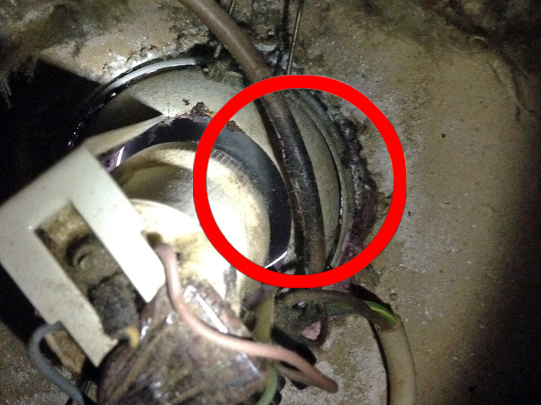Loft insulation covering a downlight, cables charred and brittle